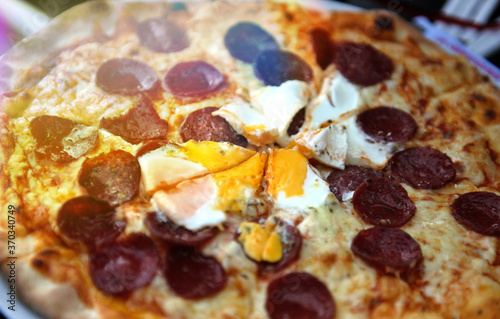 Pizza with egg and pepperoni fast food concept