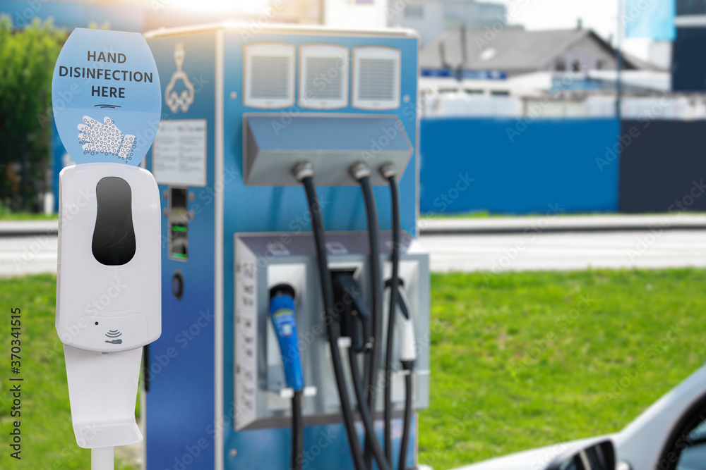 Contactless disinfection for hands on a electric vehicles charging station during the coronavirus pandemic Contactless disinfection for hands on a electric vehicles charging station during the coronavirus pandemic