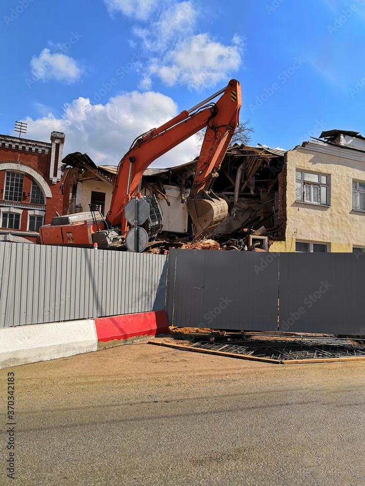 Bulldozer crushing the building at construction site Bulldozer crushing the building at construction site