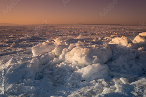 The natural landscape with the icy surface of the sea
