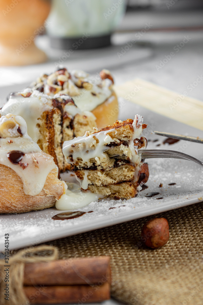 original cinnabon rolls with chocolate-cream sauce and hazelnuts