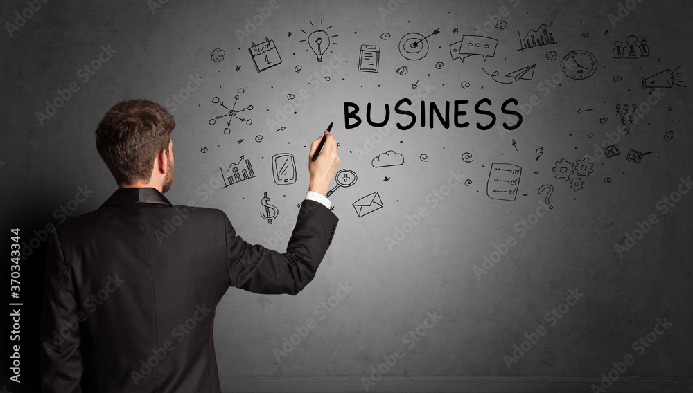 businessman drawing a creative idea sketch with BUSINESS inscription, business strategy concept