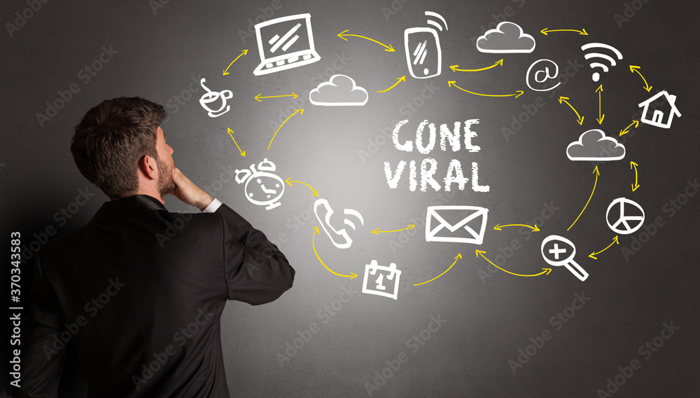 businessman drawing social media icons with GONE VIRAL inscription, new media concept