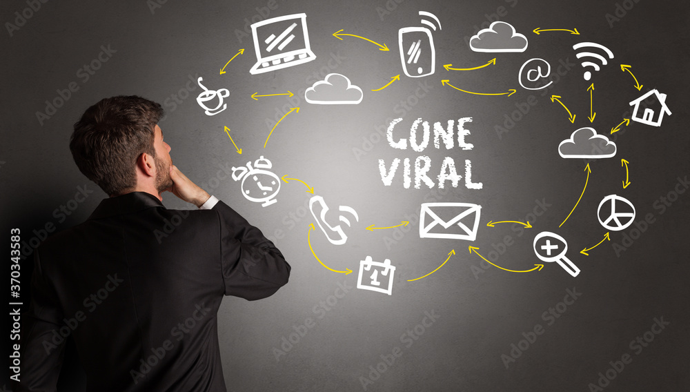 businessman drawing social media icons with GONE VIRAL inscription, new media concept businessman drawing social media icons with GONE VIRAL inscription, new media concept