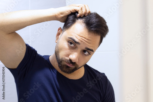 Portrait of a man worried about hair loss photo