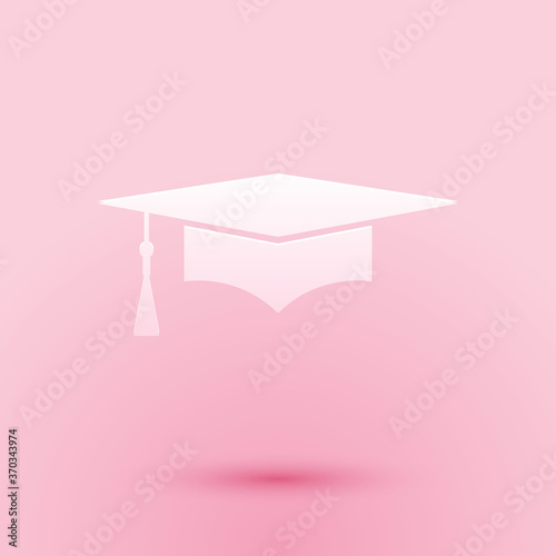 Paper cut Graduation cap icon isolated on pink background. Graduation hat with tassel icon. Paper art style. Vector.