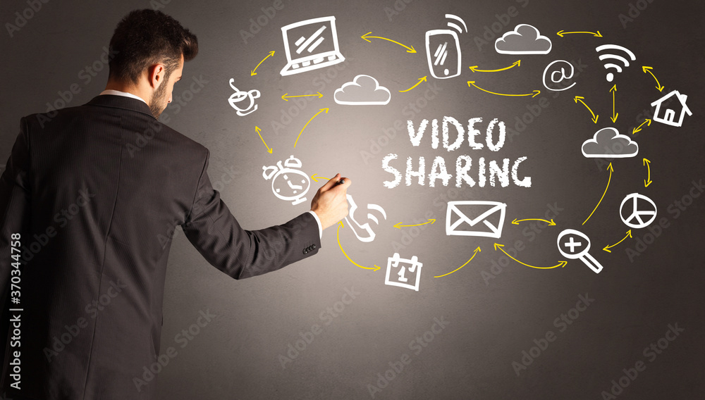 businessman drawing social media icons with VIDEO SHARING inscription, new media concept businessman drawing social media icons with VIDEO SHARING inscription, new media concept
