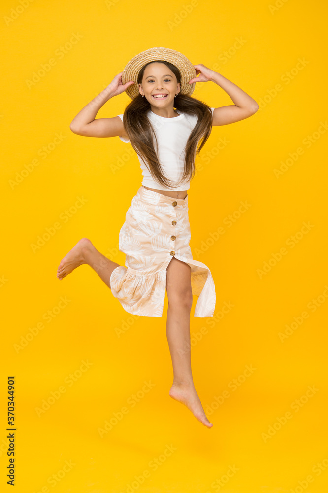 Cheerful small girl summer outfit jumping, take it easy concept Cheerful small girl summer outfit jumping, take it easy concept