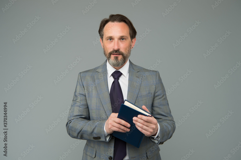 A progressive approach. planning and success. reading a book. businessman find interesting information in book. get ready for business training. successful man in business suit hold diary notebook A progressive approach. planning and success. reading a book. businessman find interesting information in book. get ready for business training. successful man in business suit hold diary notebook