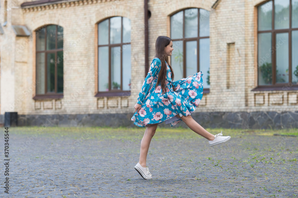 Girl summer dress flutters in motion urban background, freshness concept