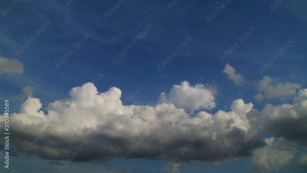 Blue sky with big shape cumulus cloud in the rainy day. Soft focus. Low key. Nature background concept.