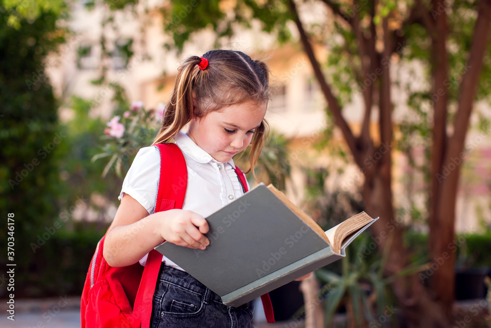 Back to school. Pupil reading book outdoor Back to school. Pupil reading book outdoor