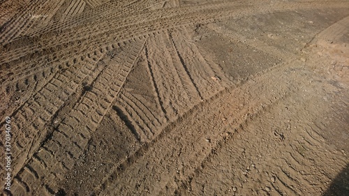 Traces of car tires in the sand that cross each other