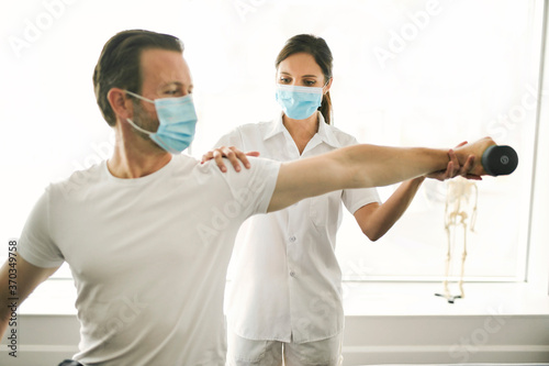 physiotherapist doing treatment with patient in bright office