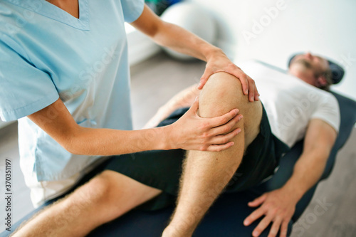 physiotherapist doing treatment with patient in bright office
