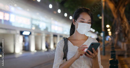 Photography Woman wear face mask and use of mobile phone at street