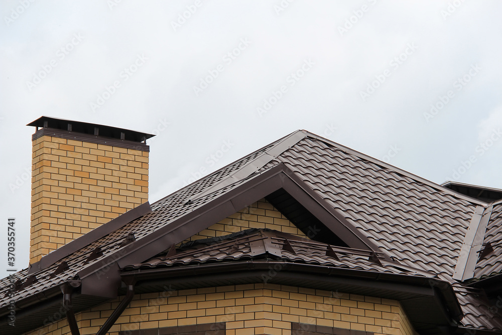 roof with new brown roofing tiles on residential property. banner on