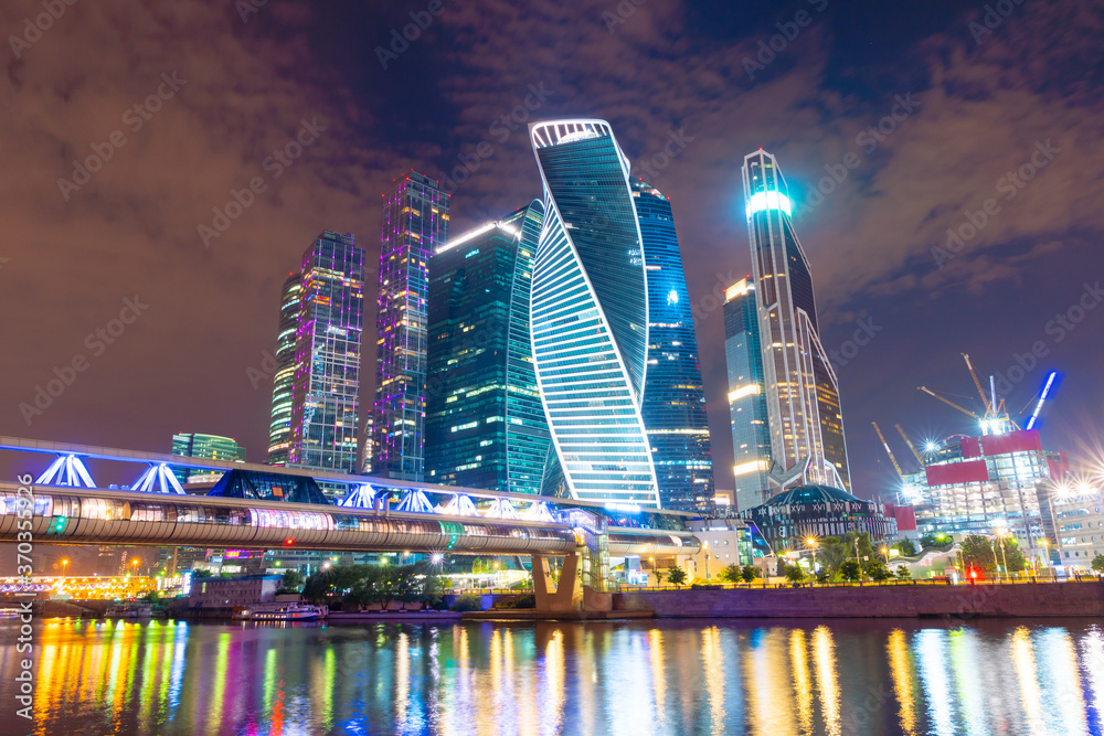 Moscow skyline panorama at night with colorful lights reflections on the surface of the river Moskva. Modern skyscrapers for business and life style in Russia.