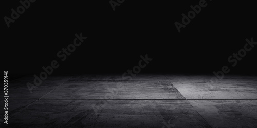 Cement floor with light in the dark background.