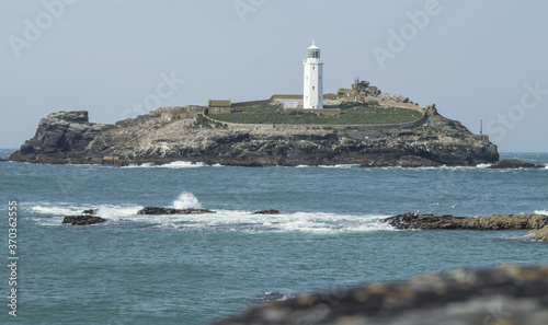 A white lighthouse at sea in Cornwall, England. © Justyna