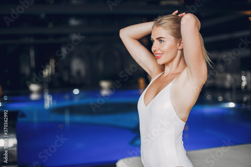 Woman in a spa salon. Blonde in a white swimsuit