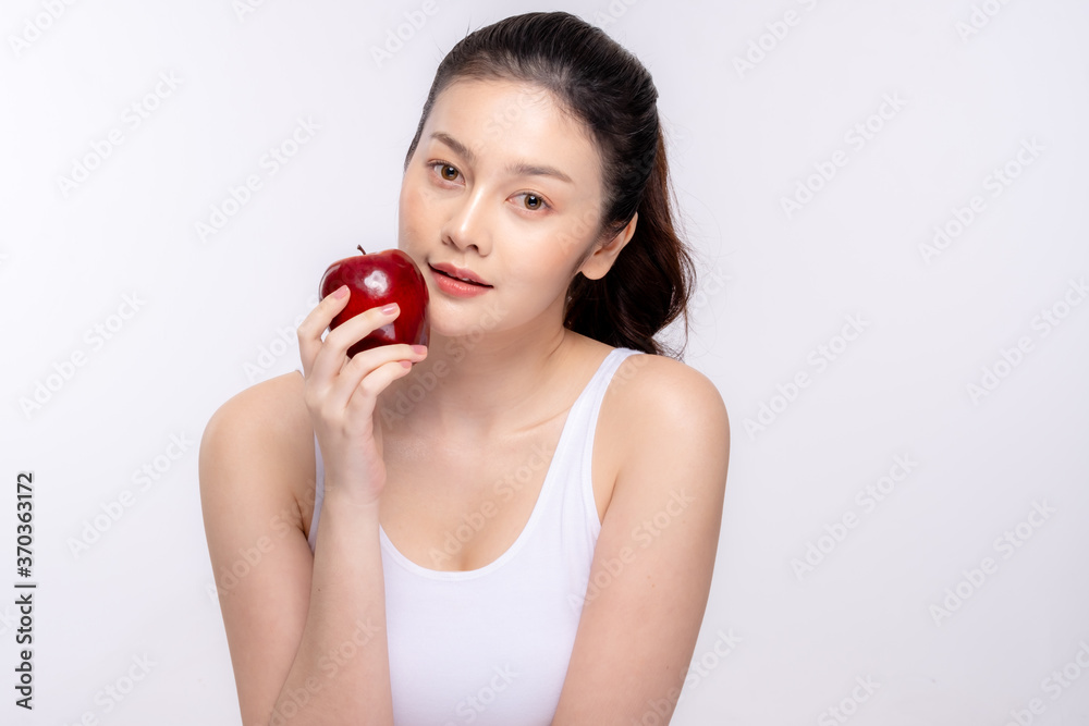 Beautiful young woman with clean fresh skin . She holds an apple. Facial treatment . Cosmetology , beauty and spa . Skin care Beautiful young woman with clean fresh skin . She holds an apple. Facial treatment . Cosmetology , beauty and spa . Skin care