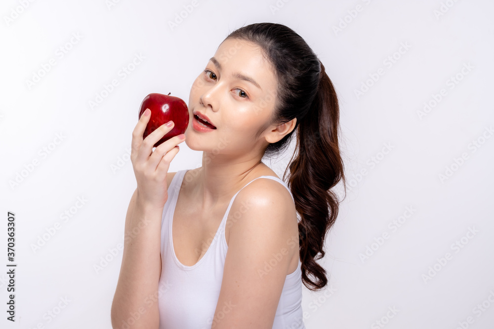 Beautiful young woman with clean fresh skin . She holds an apple. Facial treatment . Cosmetology , beauty and spa . Skin care Beautiful young woman with clean fresh skin . She holds an apple. Facial treatment . Cosmetology , beauty and spa . Skin care