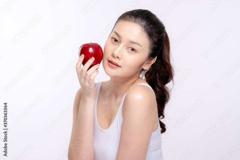 Beautiful young woman with clean fresh skin . She holds an apple. Facial treatment . Cosmetology , beauty and spa . Skin care Beautiful young woman with clean fresh skin . She holds an apple. Facial treatment . Cosmetology , beauty and spa . Skin care