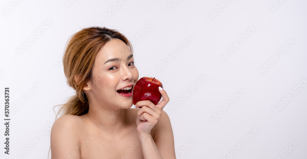 Beautiful young woman with clean fresh skin . She holds an apple. Facial treatment . Cosmetology , beauty and spa . Skin care Beautiful young woman with clean fresh skin . She holds an apple. Facial treatment . Cosmetology , beauty and spa . Skin care