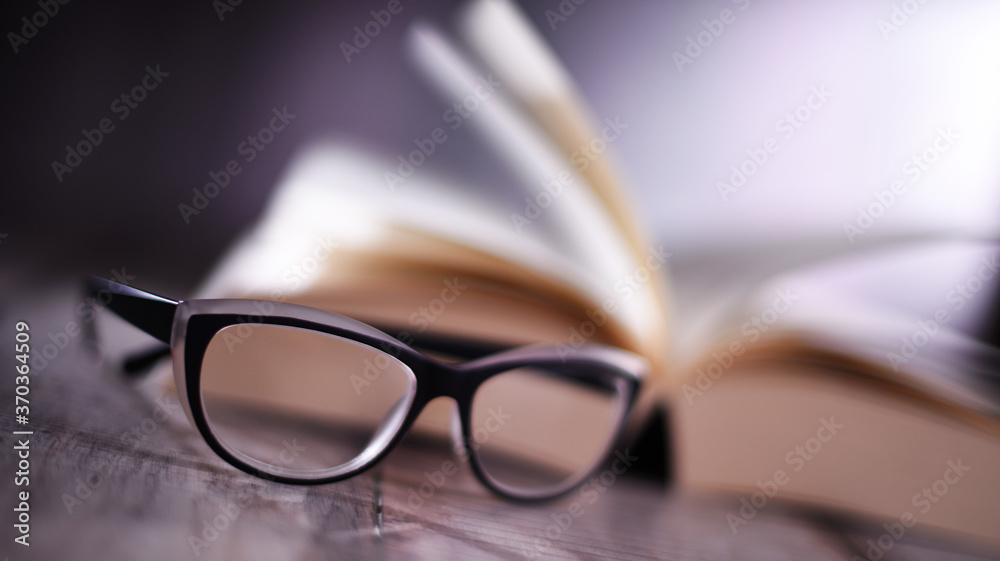 Composition with glasses and open book on the table Composition with glasses and open book on the table