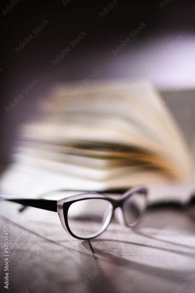 Composition with glasses and open book on the table Composition with glasses and open book on the table
