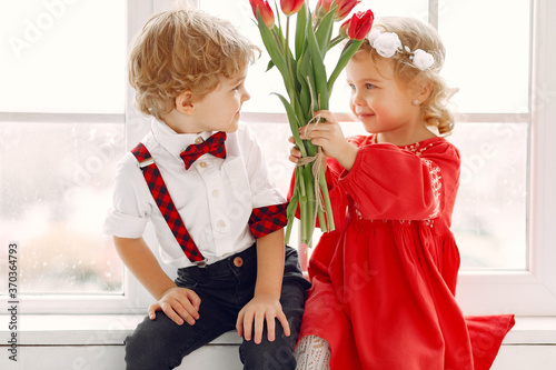 Children with flowers. Gentelman with tulip. Mother's day. Valentines day. photo