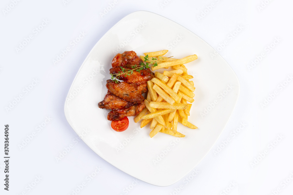 fried chicken wings and fries on a plate on a white background fried chicken wings and fries on a plate on a white background