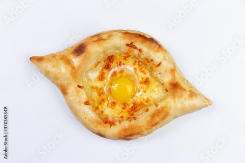 Adjar Khachapuri. Georgian national pie khachapuri with egg and cheese in the white plate isolated on white background. photo