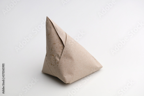 Wallpaper Mural Nasi lemak wrapped with brown paper isolated on white background.  Torontodigital.ca
