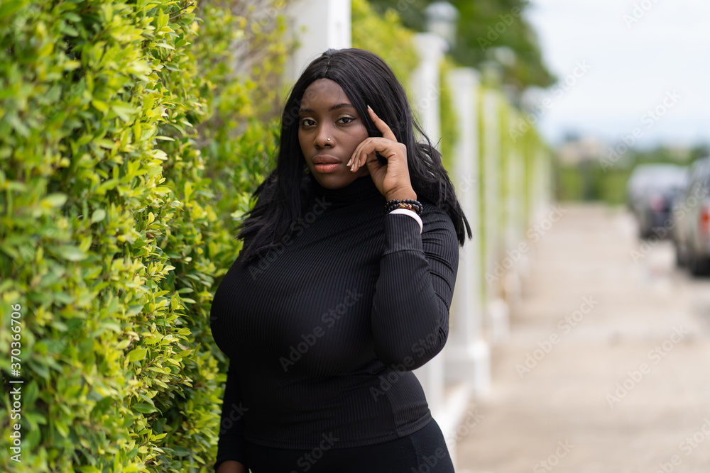 Portrait of Beautiful African fat woman standing outdoor. Black People Portrait of Beautiful African fat woman standing outdoor. Black People