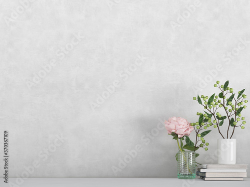 Modern room decoration. flower,  plant and books on white shelf, table against white colored wall. 