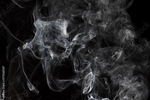 Smoke isolated on black background. Movement of white smoke