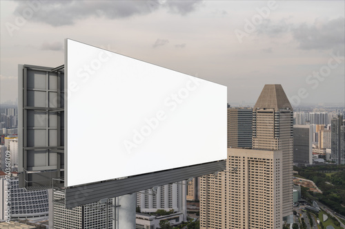 Blank white road billboard with Singapore cityscape background at sunset. Street advertising poster  mock up  3D rendering. Side view. The concept of marketing communication to sell idea.