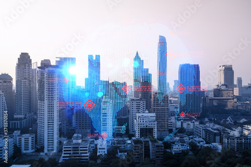 Glowing hologram of Earth planet map on aerial panoramic cityscape of Bangkok at sunset  Asia. The concept of international business. Multi Exposure.