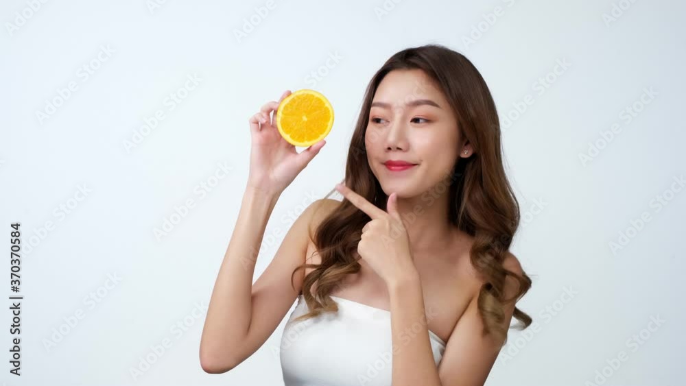 Portrait of beautiful asian woman looking to camera with attractive smile. People with beauty and skin care concept..4K UHD. young woman with oranges. Portrait of beautiful asian woman looking to camera with attractive smile. People with beauty and skin care concept..4K UHD. young woman with oranges.