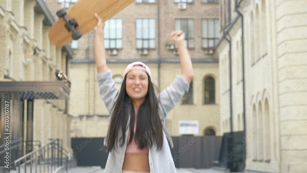 Funny woman holding skateboard, jumping and screaming. Slowmotion. Funny woman holding skateboard, jumping and screaming. Slowmotion.