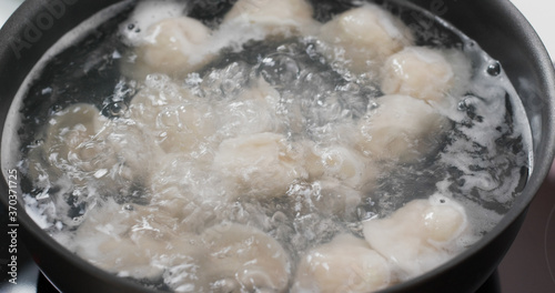 Cooking with meat dumpling in kitchen