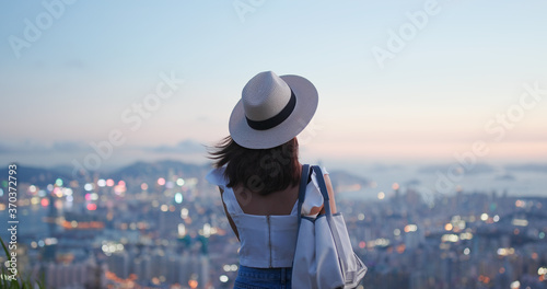 Photography Woman look at the beautiful city view at sunset