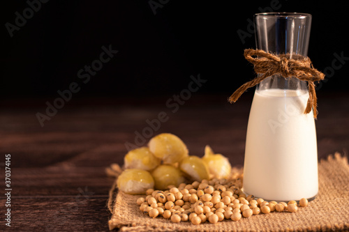 Принти на полотні Soy products soy beans, soy milk, moon cake on black background