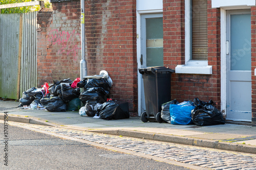 Plastic bin bags full of rubbish outside a home ready for collection by bin men on bin collection day