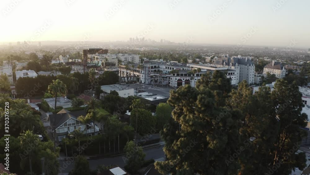 Aerial drone shot in West Hollywood looking out toward the tall skyscraper of downtown LA at sunset Aerial drone shot in West Hollywood looking out toward the tall skyscraper of downtown LA at sunset