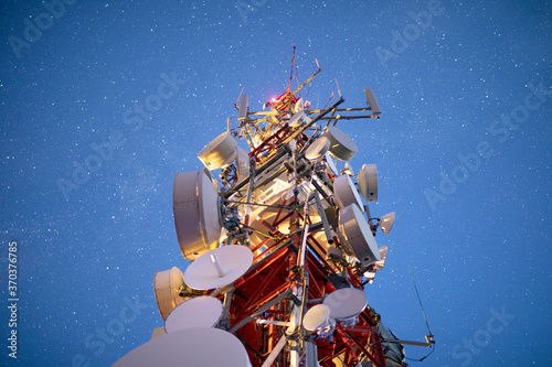 stars in night sky above radio tower