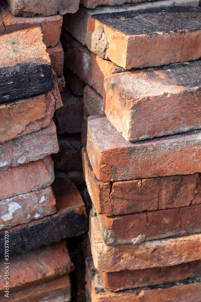 A stack of red not new fire bricks for laying a home stove A stack of red not new fire bricks for laying a home stove