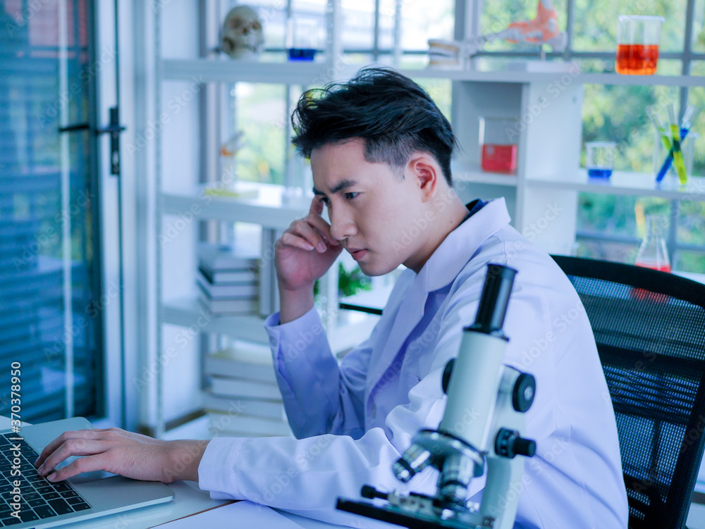 Asian medical doctor wearing lab gown working in science clinical laboratory testing for covid-19 corona virus pandemic biohazard new normal in hospital Asian medical doctor wearing lab gown working in science clinical laboratory testing for covid-19 corona virus pandemic biohazard new normal in hospital